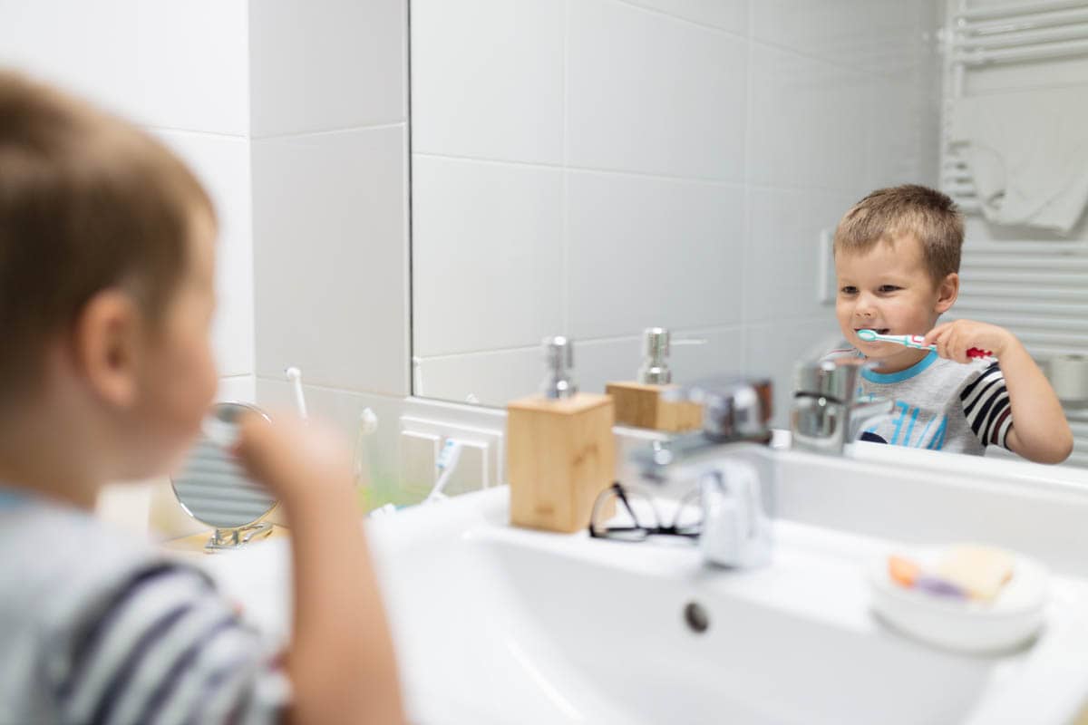 Adorable child brushing his teeth