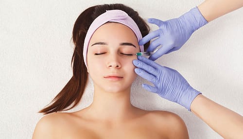 Woman getting beauty injection at salon
