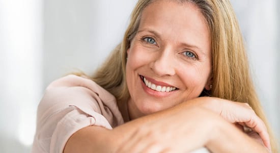 Smiling mature woman on couch